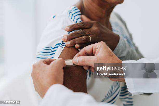 bandage after applying vaccine - booster stock pictures, royalty-free photos & images