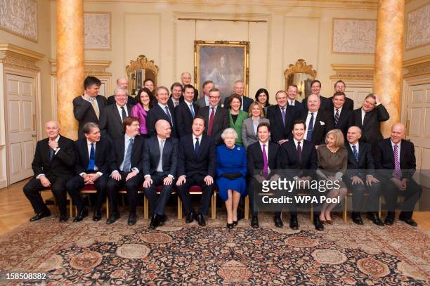Queen Elizabeth II poses with British Prime Minister David Cameron and cabinet ministers in The Pillared Room at Number 10 Downing Street to attend...