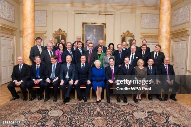 Queen Elizabeth II poses with British Prime Minister David Cameron and cabinet ministers in The Pillared Room at Number 10 Downing Street to attend...