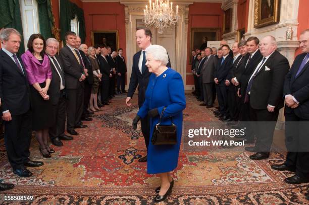 Queen Elizabeth II arrives with British Prime Minister David Cameron to meet members of the cabinet at Number 10 Downing Street as she attends the...