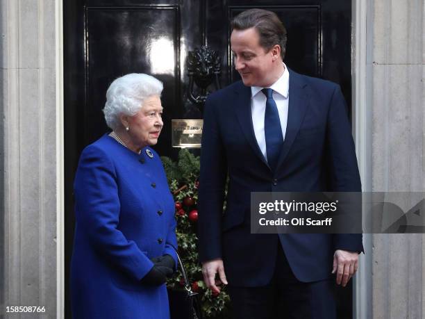 British Prime Minister David Cameron greets Her Majesty Queen Elizabeth II as she arrives at Number 10 Downing Street to attend the Government's...