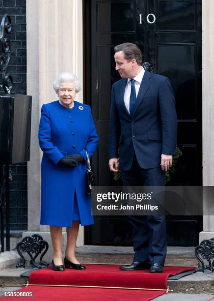 British Prime Minister David Cameron greets Her Majesty Queen Elizabeth II as she arrives at Number 10 Downing Street to attend the Government's...