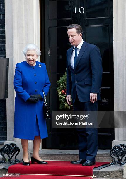 British Prime Minister David Cameron greets Her Majesty Queen Elizabeth II as she arrives at Number 10 Downing Street to attend the Government's...