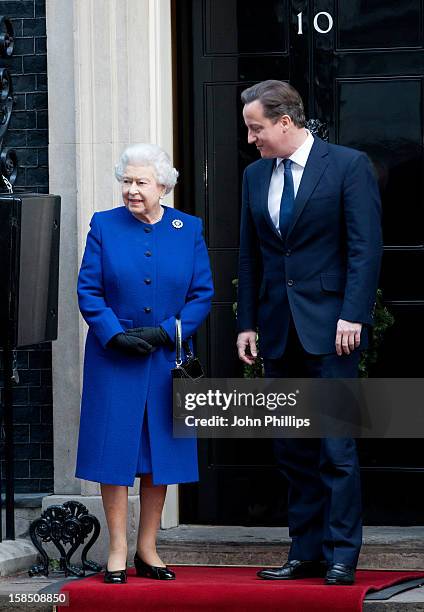 British Prime Minister David Cameron greets Her Majesty Queen Elizabeth II as she arrives at Number 10 Downing Street to attend the Government's...