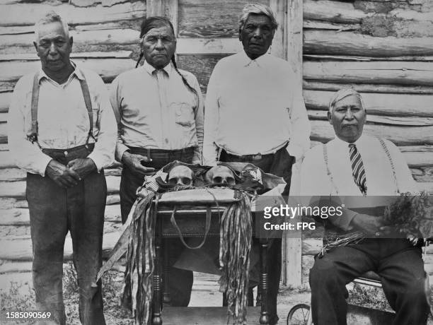 Native American Gros Ventre elders Foolish Bear and Drags Wolf, of the Water Busters clan, pose with two other Water Busters elders and the Sacred...
