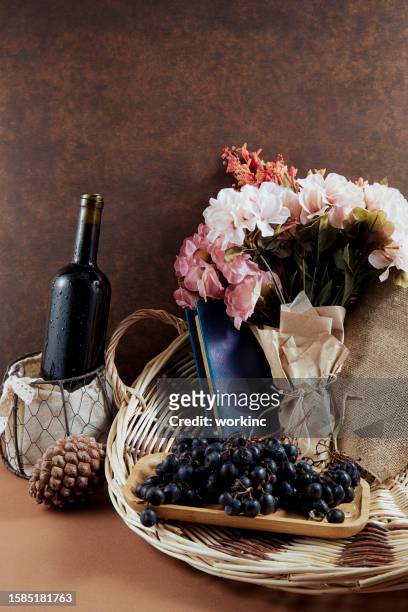 bottle of wine and grapes with flower bouquet - flower presents bildbanksfoton och bilder