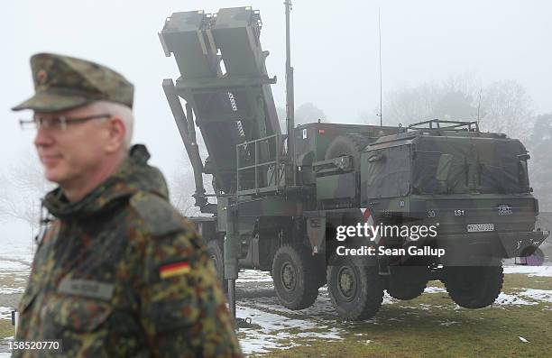 Member of the German Bundeswehr stands next to a Patriot missile launching system during a press day at the Luftwaffe Warbelow training center on...