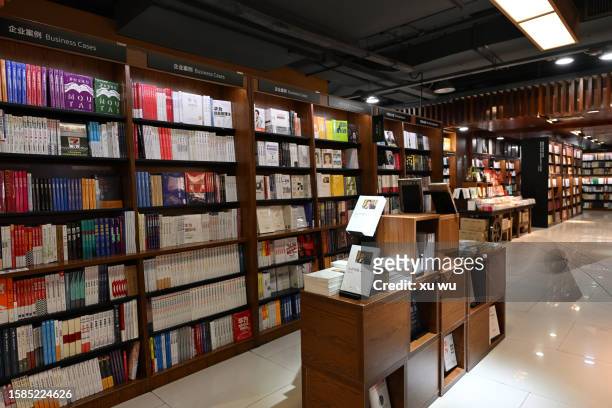 bookshelves full of books in a bookstore - book shop stock pictures, royalty-free photos & images