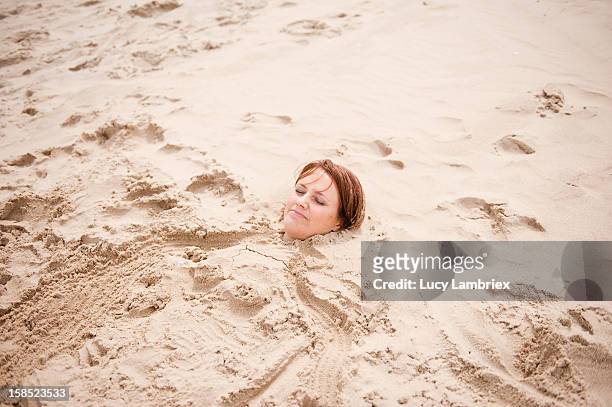 mermaid in sand - buried in sand stockfoto's en -beelden
