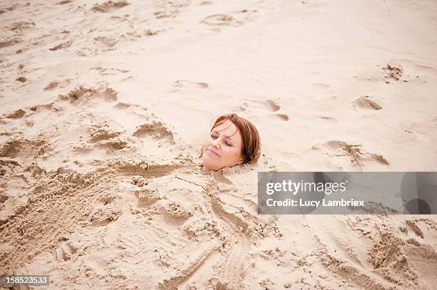 mermaid in sand - woman buried sand stock pictures, royalty-free photos & images