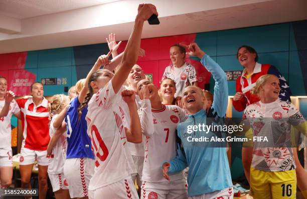 Signe Bruun, Sanne Troelsgaard and Pernille Harder of Denmark celebrate with teammates in the dressing room after their team advanced to the...