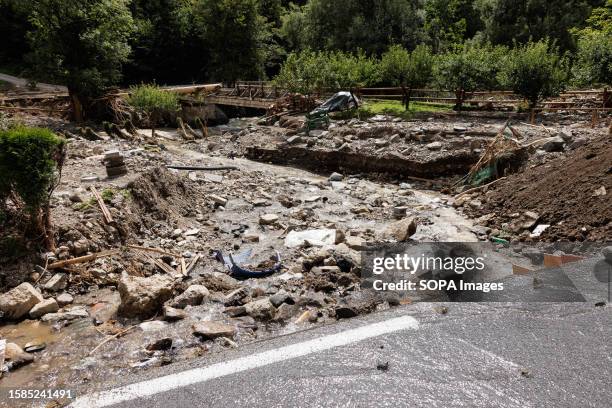Water runs from a damaged road towards a destroyed bridge in Raduha after major flooding hit two thirds of the country days ago. Clean-up and rescue...