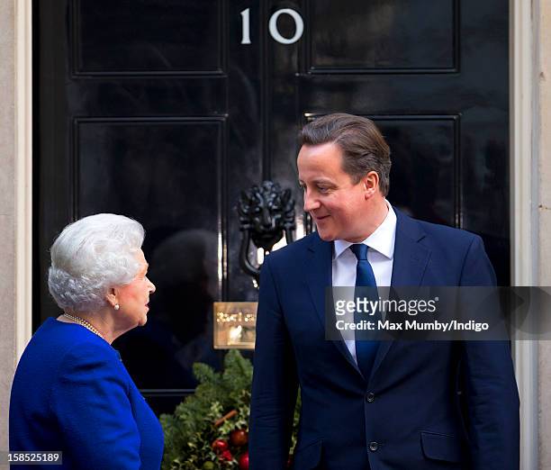 Queen Elizabeth II is greeted by British Prime Minister David Cameron on the doorstep of Number 10 Downing Street as she arrives to attend the...