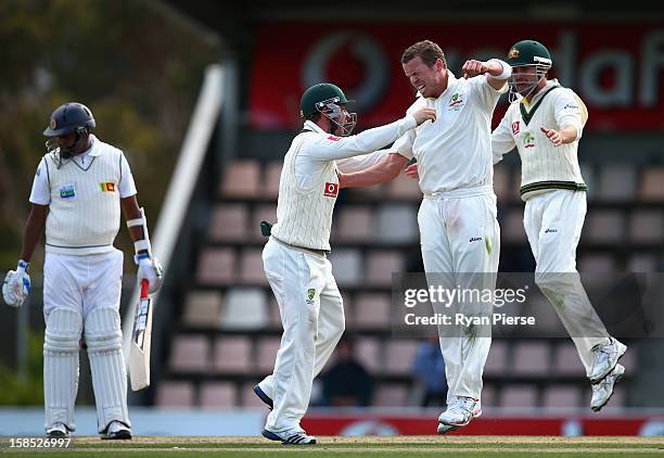 Peter Siddle of Australia celebrates after taking the wicket of Thilan Samaraweera of Sri Lanka during day five of the First Test match between...