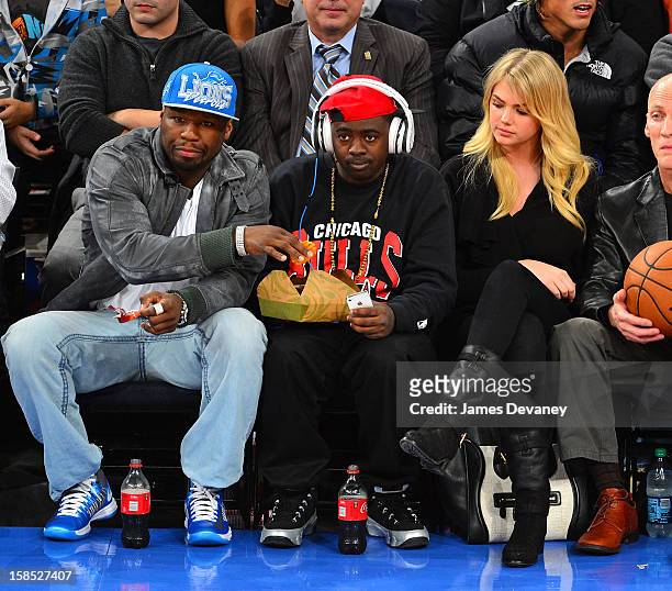 Cent, guest and Kate Upton attend the Houston Rockets vs New York Knicks game at Madison Square Garden on December 17, 2012 in New York City.