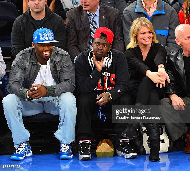 Cent, guest and Kate Upton attend the Houston Rockets vs New York Knicks game at Madison Square Garden on December 17, 2012 in New York City.