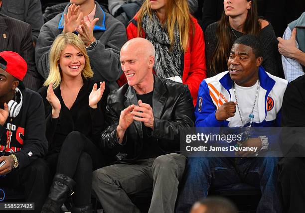 Kate Upton, guest and Tracy Morgan attend the Houston Rockets vs New York Knicks game at Madison Square Garden on December 17, 2012 in New York City.