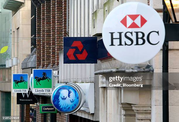 Signs sit outside branches of a Lloyds TSB bank, part of the Lloyds Banking Group Plc, a Barclays Plc bank, a NatWest bank, part of the Royal Bank of...