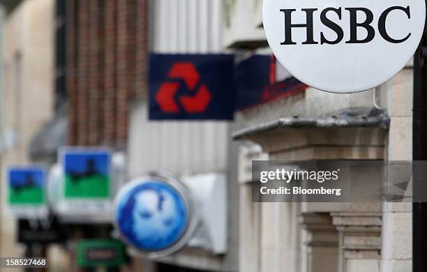 Signs sit outside branches of a Lloyds TSB bank, part of the Lloyds Banking Group Plc, a Barclays Plc bank, a NatWest bank, part of the Royal Bank of...