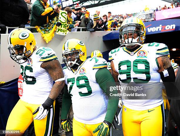 Jordan Miller of the Green Bay Packers, Ryan Pickett and Jerel Worthy take the field for a game against the Chicago Bears on December 16, 2012 at...