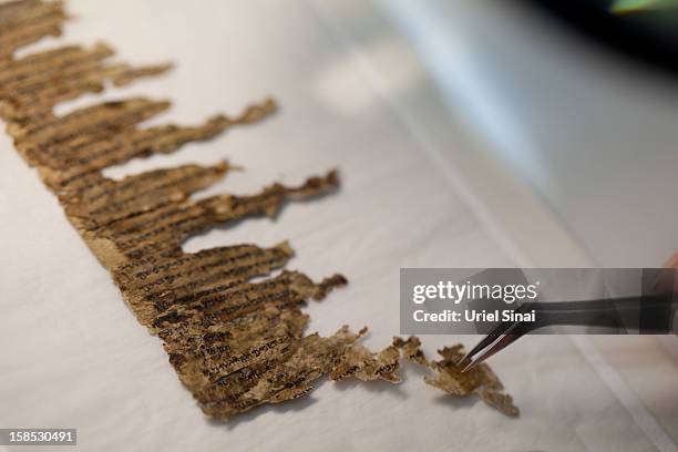 Conservation analyst from the Israeli Antiquities department examines fragments of the 2000-year-old Dead Sea scrolls at a laboratory before...