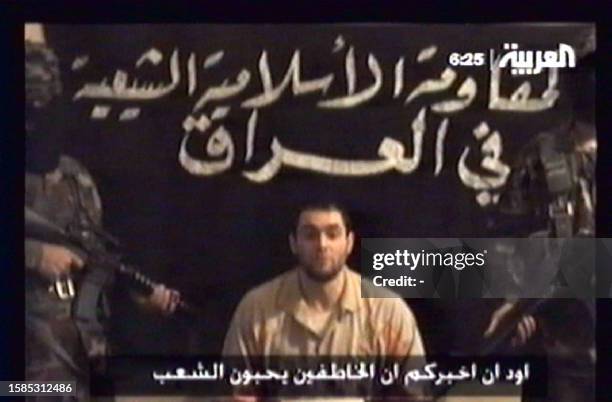 Frame-grab from a video broadcast 03 December 2007 by the Dubai-based pan-Arab Al-Arabiya news channel shows an alleged hostage flanked by two masked...