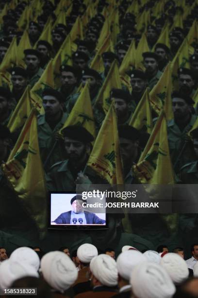 Hezbollah Secretary General Hassan Nasrallah addresses supporters in a televised speech during a rally held in the predominantly Shiite Muslim...