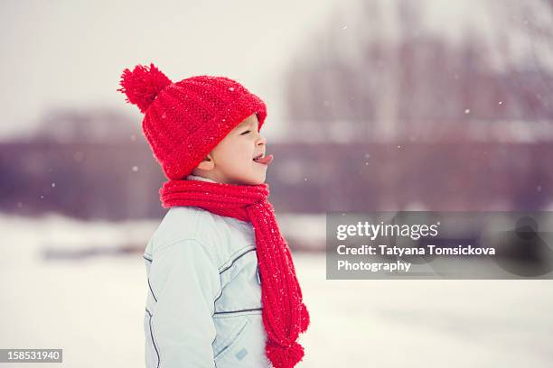trying to catch snowflakes - red scarf stock-fotos und bilder