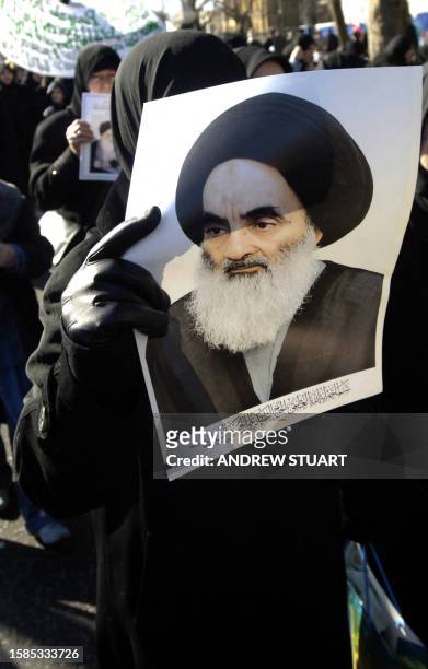 Muslim woman holds a portrait of Shia leader Imam Sistani during a demosntration by Shia Muslims from Piccadilly to Trafalgar Square in London, 25...