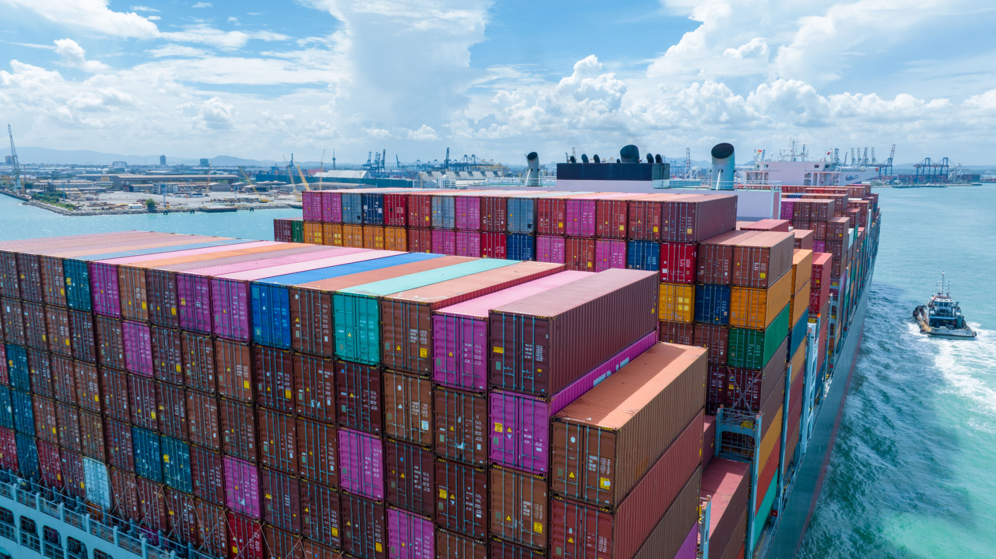 Stern of large cargo container ship import export container box on the ocean sea on blue sky back ground concept transportation logistic and service to customer and supply change Stern of large cargo container ship import export container box on the ocean sea on blue sky back ground concept transportation logistic and service to customer and supply change