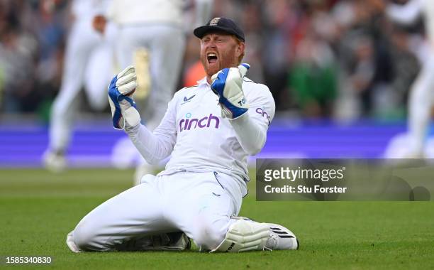 England wicketkeeper Jonny Bairstow celebrates after combining with bowler Stuart Broad to take the wicket of Todd Murphy during day five of the LV=...