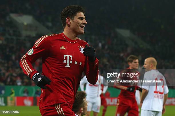 Mario Gomez of Muenchen celebrates scoring the opening goal during the DFB cup round of sixteen match between FC Augsburg and FC Bayern Muenchen at...