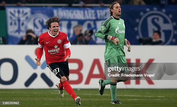Timo Hildebrand of Schalke looks on and Nicolai Mueller of Mainz celebrates after winning the DFB cup round of sixteen match between FC Schalke 04...