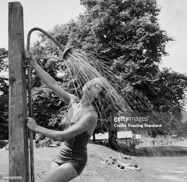 Woman takes a shower beside the Serpentine lake in Hyde Park, London, July 28th 1959.