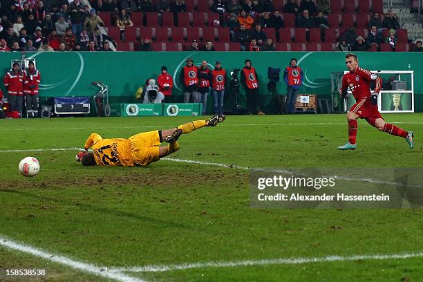 Xherdan Shaqiri of Muenchen scores the 2nd team goal against Alexander Manninger, keeper of Augsburg during the DFB cup round of sixteen match...