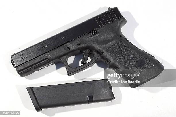 In this photo illustration, a Glock pistol with a 17 round magazine is seen on December 18, 2012 in Miami, Florida. The weapon is the same type that...