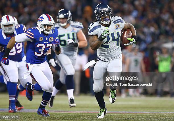 Marshawn Lynch of the Seattle Seahawks runs for a big gain during an NFL game as George Wilson of the Buffalo Bills and Marcell Dareus give chase at...