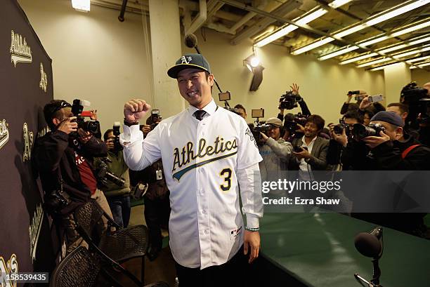 Hiroyuki Nakajima of Japan poses for photographers after he was introduced by the Oakland Athletics at the O.co Coliseum on December 18, 2012 in...