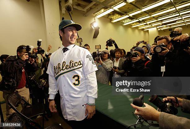 Hiroyuki Nakajima of Japan poses for photographers after he was introduced by the Oakland Athletics at the O.co Coliseum on December 18, 2012 in...
