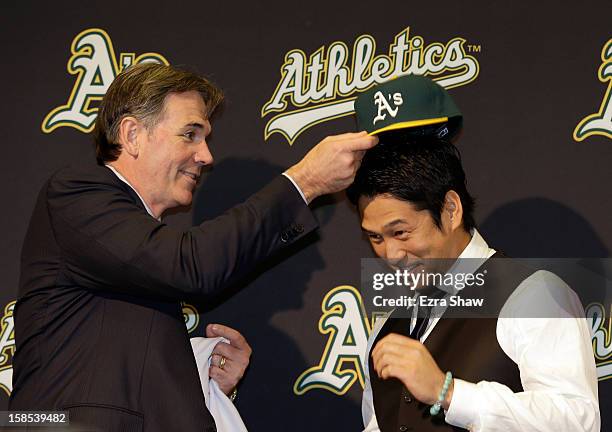 Oakland Athletics vice president and general manager Billy Beane introduces Hiroyuki Nakajima of Japan to the Oakland Athletics at the O.co Coliseum...