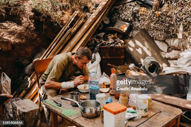 Ukrainian soldier, from the 24th separate mechanized brigade, named after King Danylo, eats his dinner in the front line positions near New York,...