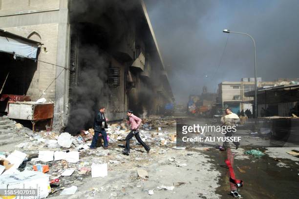 Iraqis evacuate the site where a car bomb exploded in central Baghdad 12 February 2007, ripping through popular Shiite market areas and killing at...