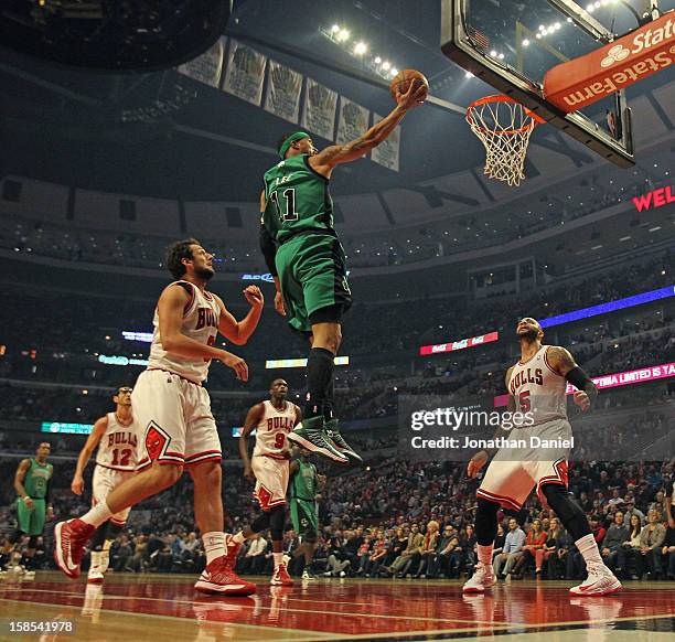 Courtney Lee of the Boston Celtics goes up betrween Marco Belinelli and Carlos Boozer of the Chicago Bulls at the United Center on December 18, 2012...