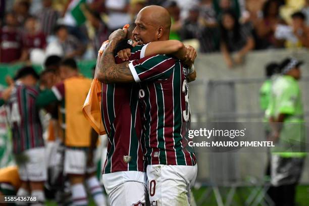 Fluminense's midfielder Felipe Melo celebrates with a teammate after defender Samuel Xavier scored their team's first goal during the Copa...