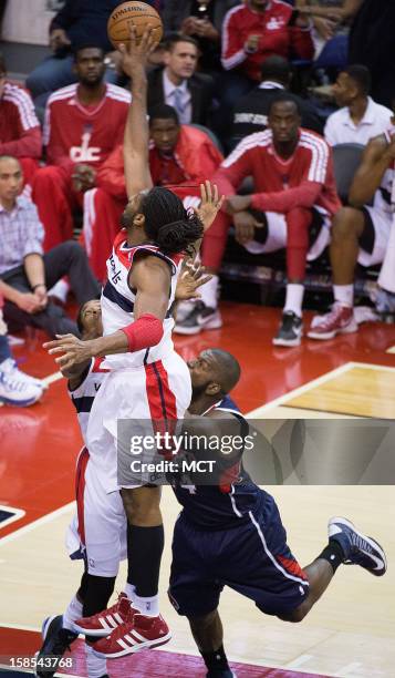 Washington Wizards center Nene blocks the shoot of Atlanta Hawks power forward Ivan Johnson during the second half of their game played at the...