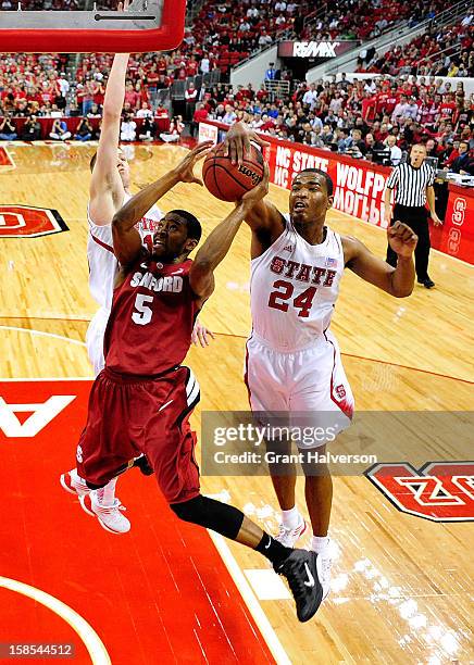 Warren of the North Carolina State Wolfpack blocks a shot by Chasson Randle of the Stanford Cardinal during play at PNC Arena on December 18, 2012 in...