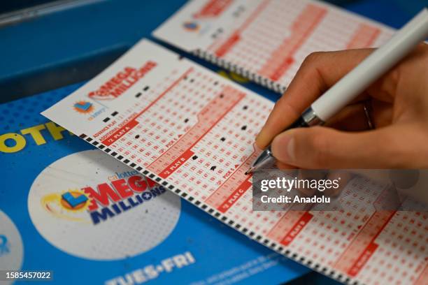 Person plays lottery at a 7-eleven store as Mega Millions jackpot reaches $ 1 billion 580 million, in Redwood City, California, United States on...
