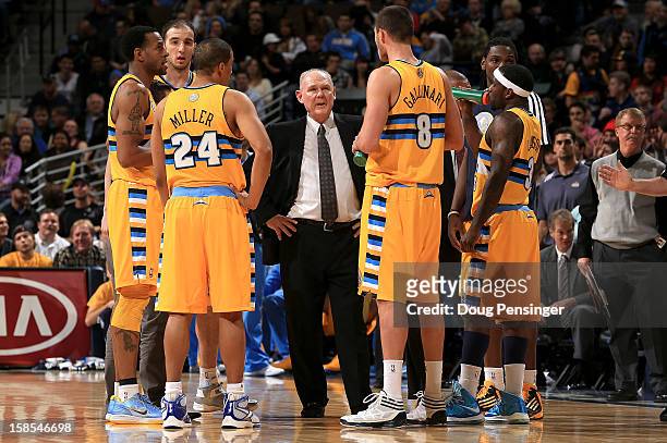 Head coach George Karl of the Denver Nuggets huddles his team during a break in the action against the San Antonio Spurs at the Pepsi Center on...