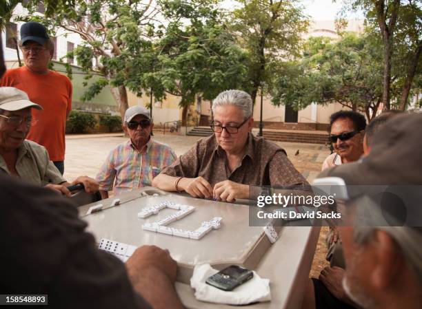 men playing dominos - san juan puerto rico fotografías e imágenes de stock