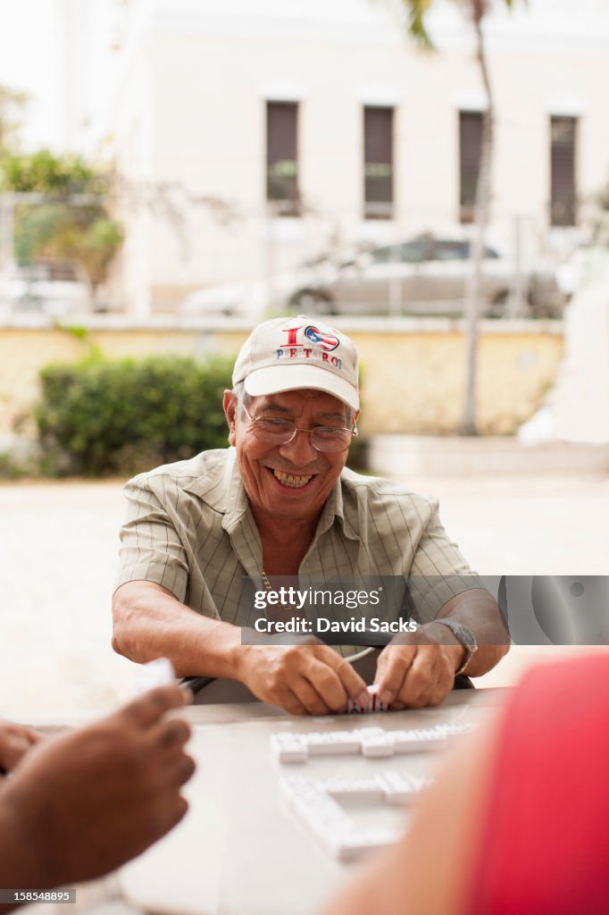 Man smiling with dominos